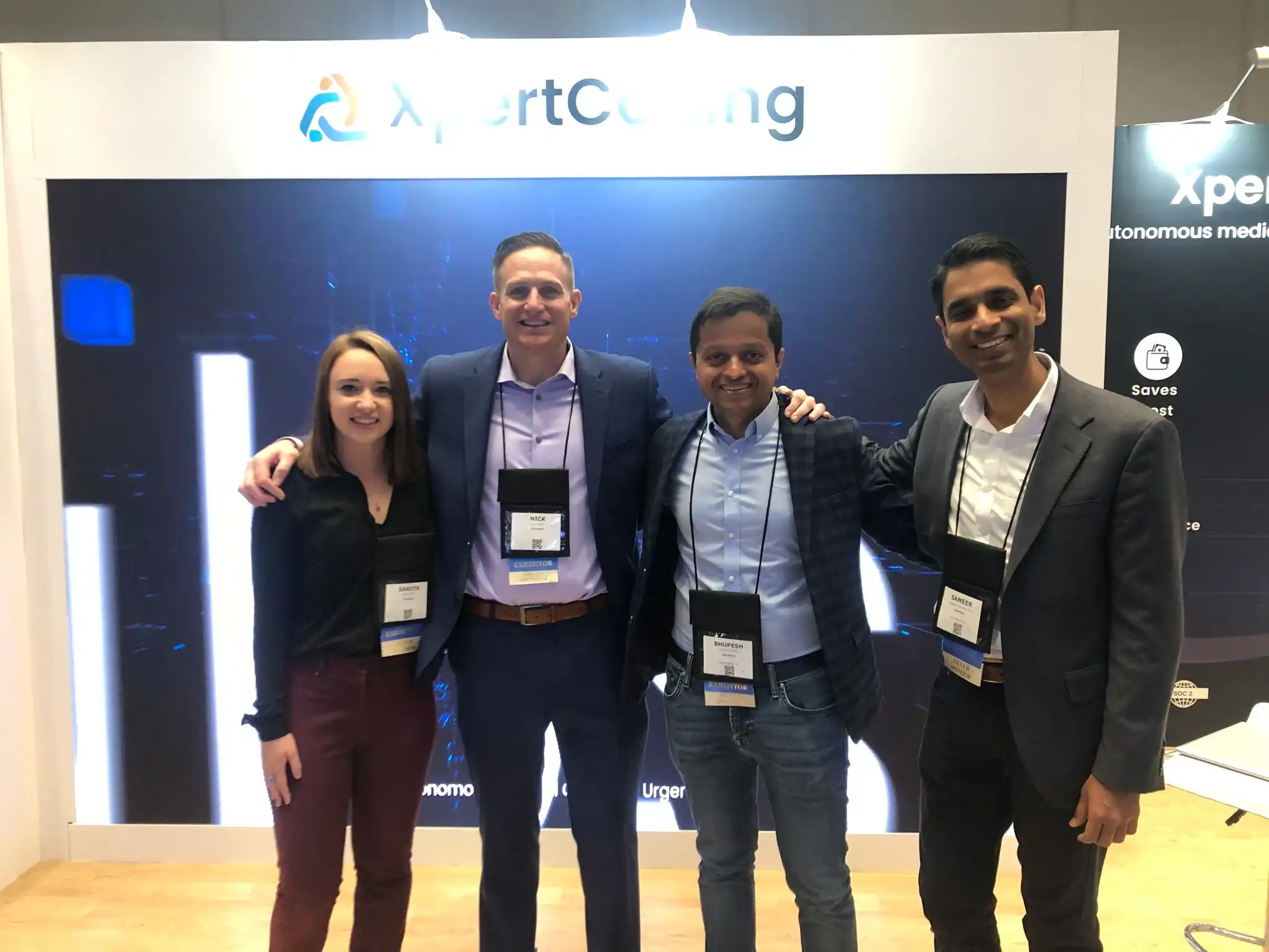 From left to right, Dakota Tippet, Nick Pierce, Dr. Bhupesh Panwar, and Dr. Sameer Ather in front of the XpertCoding booth at the Urgent Care Conference 2023.